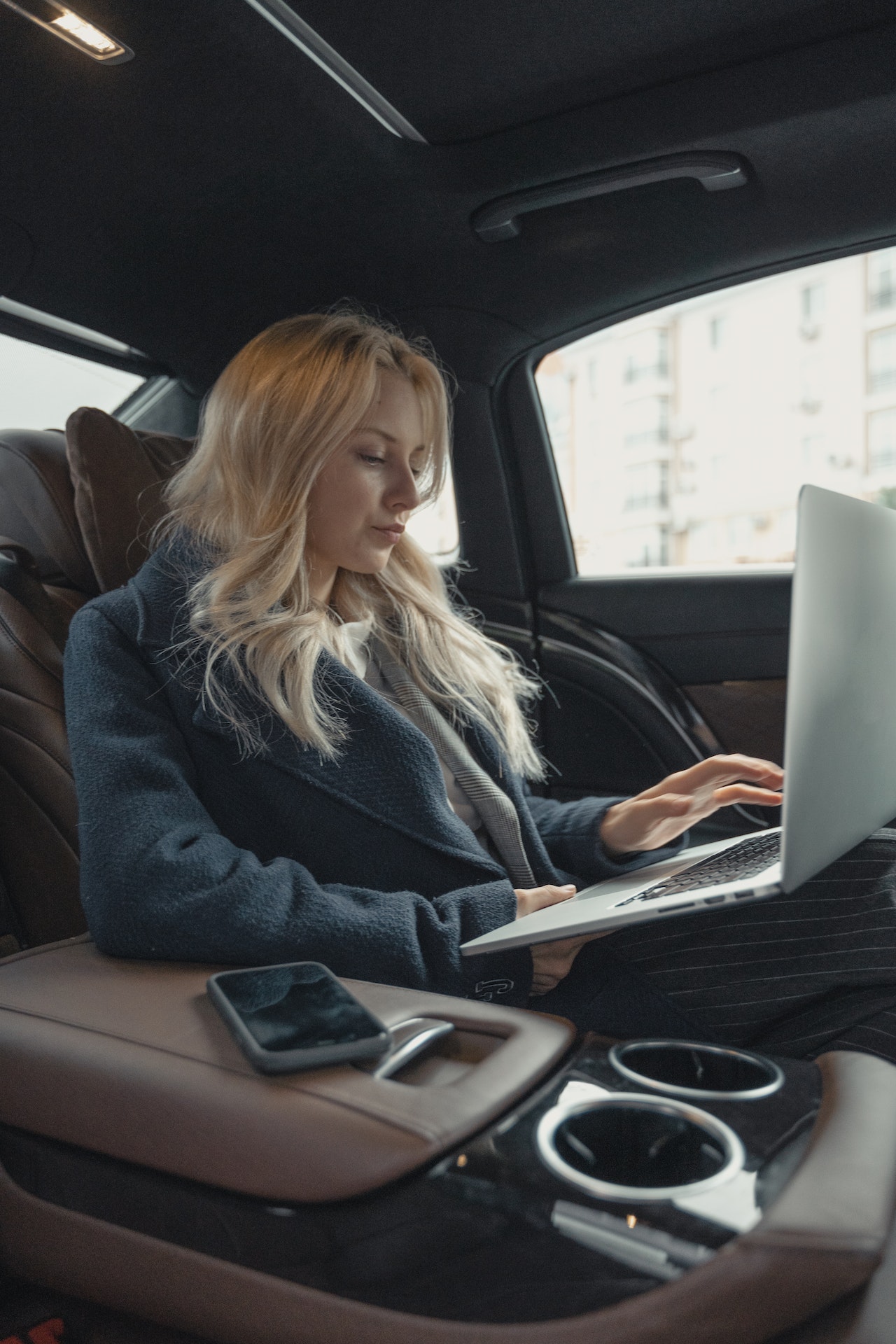Photo by Tima Miroshnichenko: https://www.pexels.com/photo/woman-in-gray-business-suit-sitting-at-the-back-seat-of-a-luxurious-car-5717642/