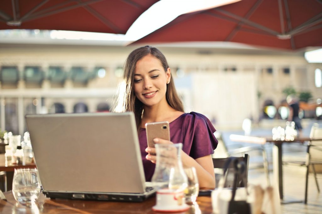 Photo by Andrea Piacquadio: https://www.pexels.com/photo/woman-wearing-purple-shirt-holding-smartphone-white-sitting-on-chair-826349/
